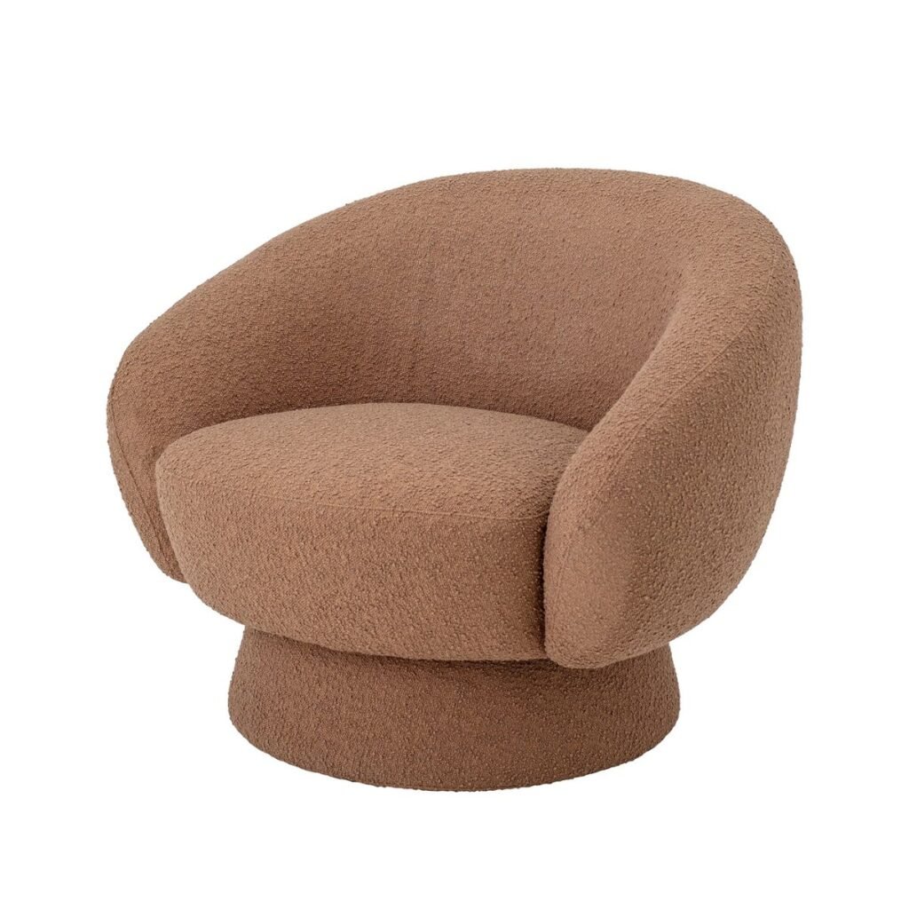 Fauteuil arrondi en bouclette terracotta, avec assise généreuse et dossier enveloppant, reposant sur un piètement cylindrique assorti.